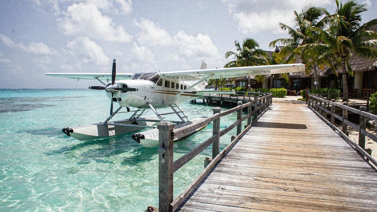 Seaplane docked at a Maldives resort jetty in daylight